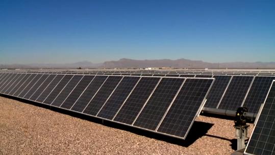 Close-up of solar panels with tracking mechanisms, representing renewable energy projects.